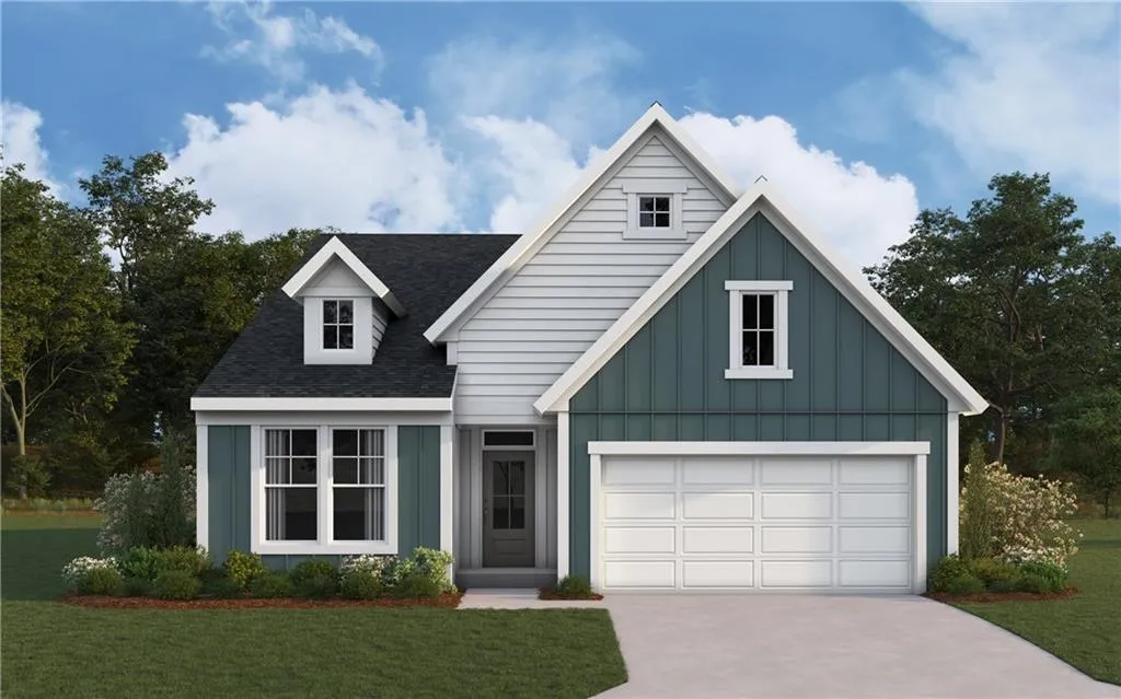 View of front of house with board and batten siding, a shingled roof, a front lawn, and driveway