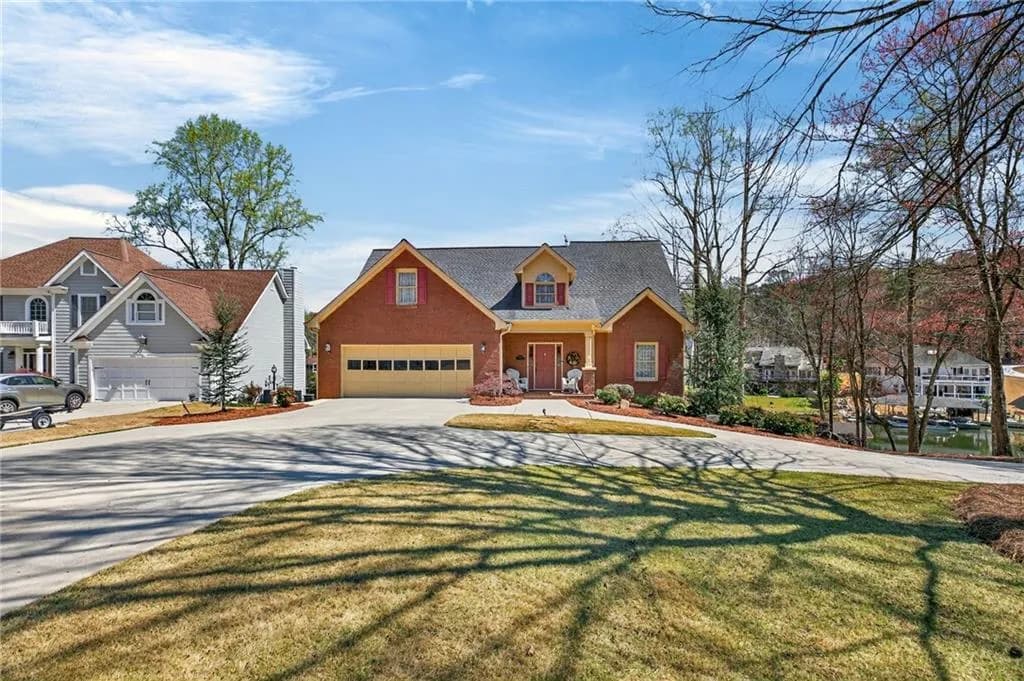 View of front of house with a porch, driveway, a front yard, brick siding, and a garage