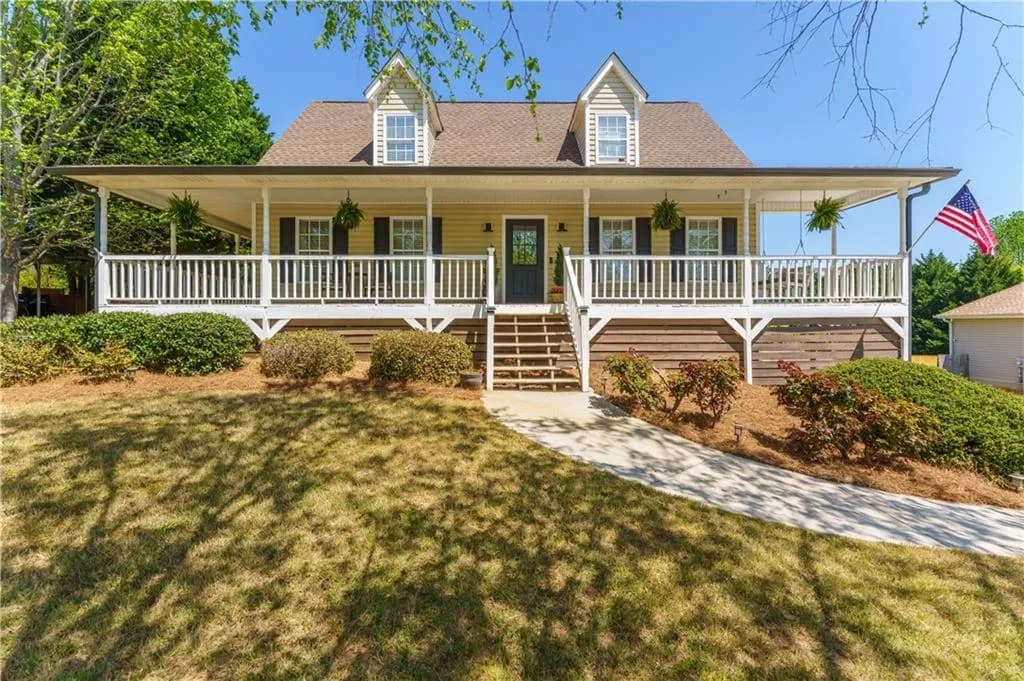 Welcome home to this charming farmhouse with wraparound porch.