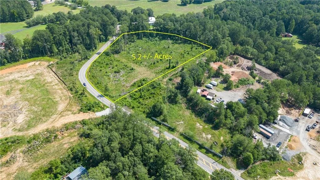 Aerial view of sparsely populated area featuring property parcel outlined