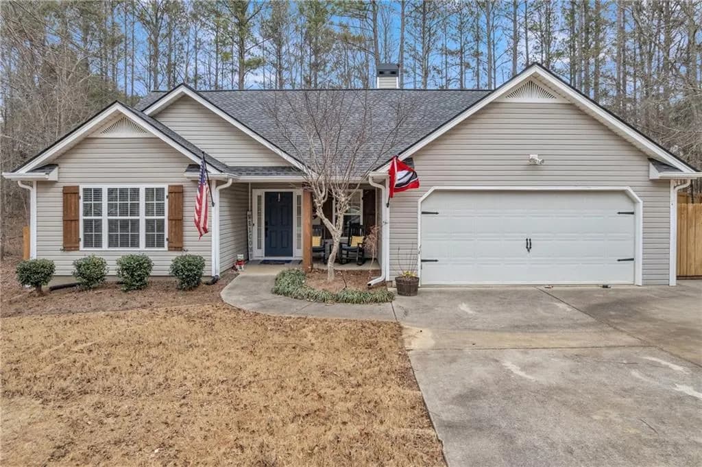 Ranch-style home featuring covered porch, concrete driveway, roof with shingles, and a garage
