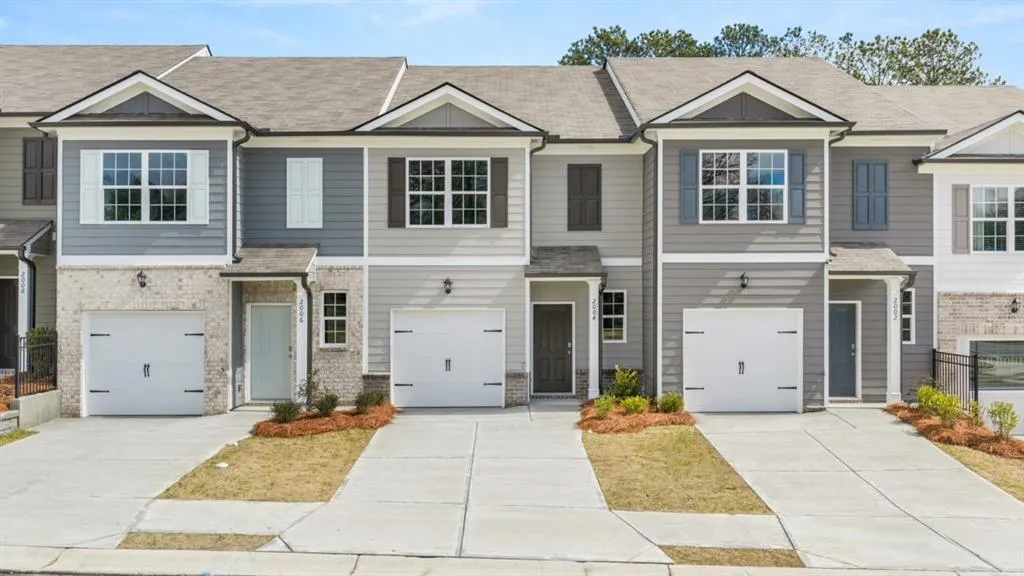 Craftsman house with a shingled roof, concrete driveway, an attached garage, and brick siding