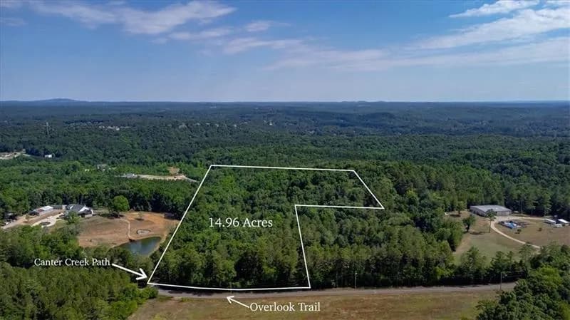 Aerial view of property's location featuring a forest and property parcel outlined