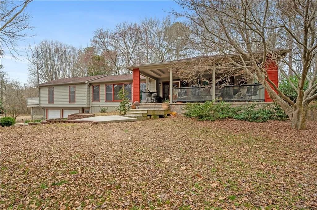 Exterior Front – This spacious 5-bedroom, 4.5-bath home sits on 3.83 private acres, offering a peaceful setting just minutes from Downtown Dallas. A welcoming covered front porch with stone accents provides the perfect space to relax and enjoy the natural surroundings.