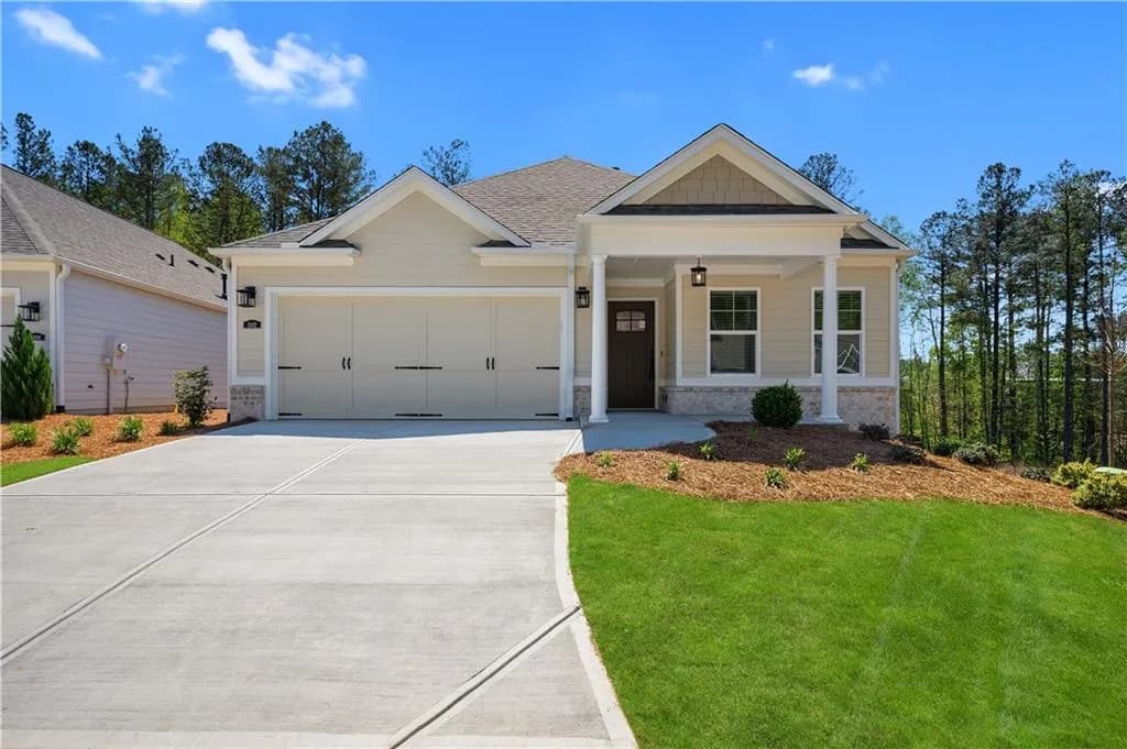 View of front of home with a garage, a porch, concrete driveway, and a shingled roof.