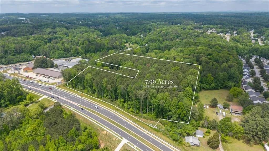 This exceptional 7.99-acre tract, situated at the high-traffic intersection of Macland Road and Maxwell Road, represents a premier development opportunity in Paulding County. The property features expansive road frontage and a level, wooded topography that offers both privacy and visibility.