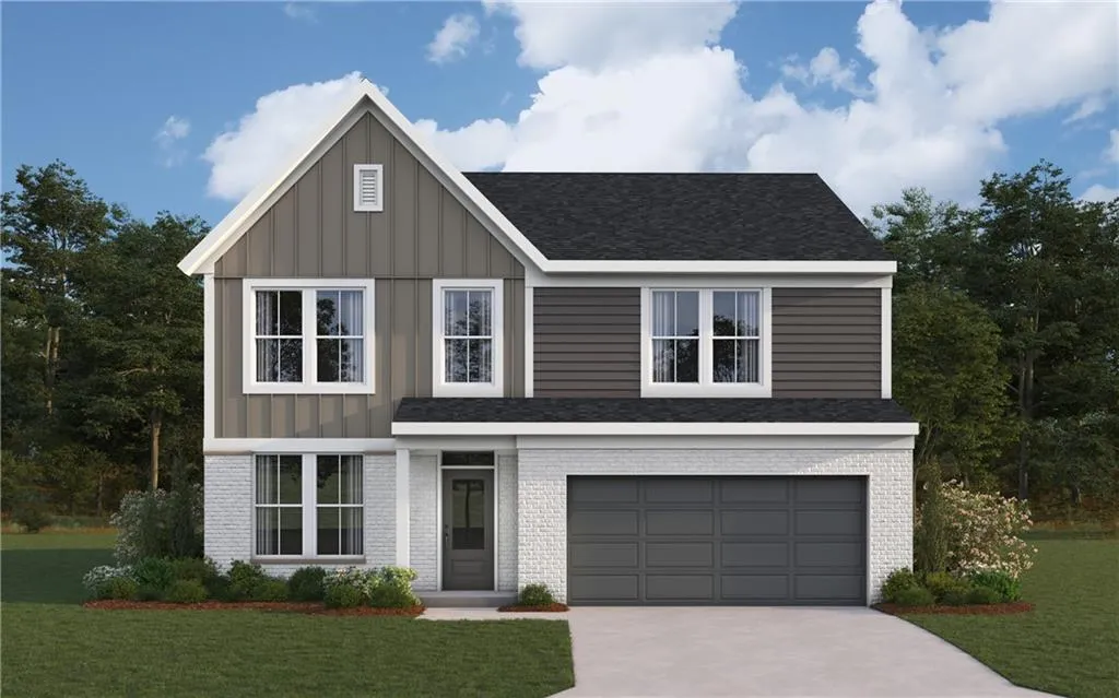 View of front of home with a garage, a front lawn, brick siding, and driveway