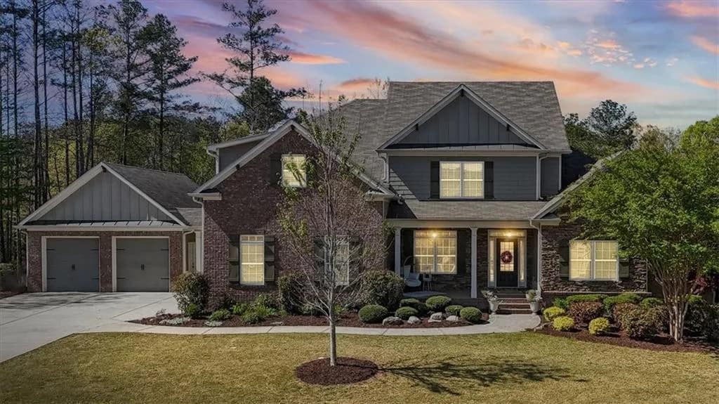 Craftsman-style house with board and batten siding, a lawn, a porch, and driveway