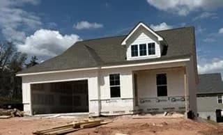 View of front facade with a porch and an attached garage