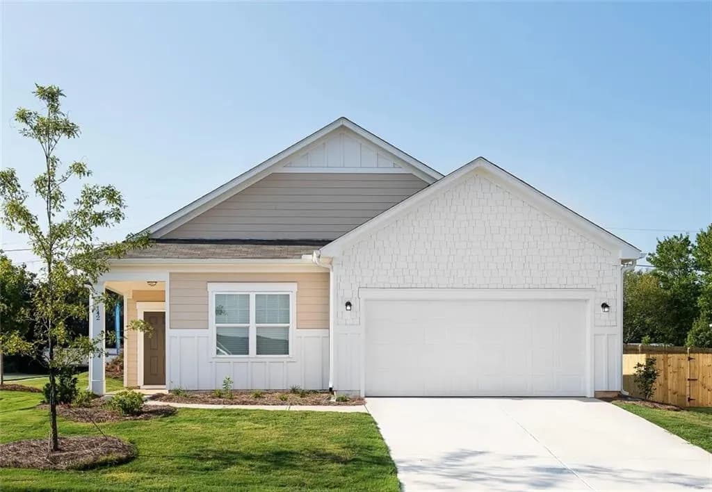 View of front facade with a garage, concrete driveway, and board and batten siding