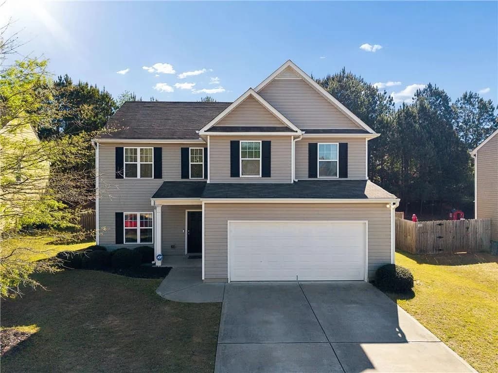 Traditional home featuring a garage and driveway