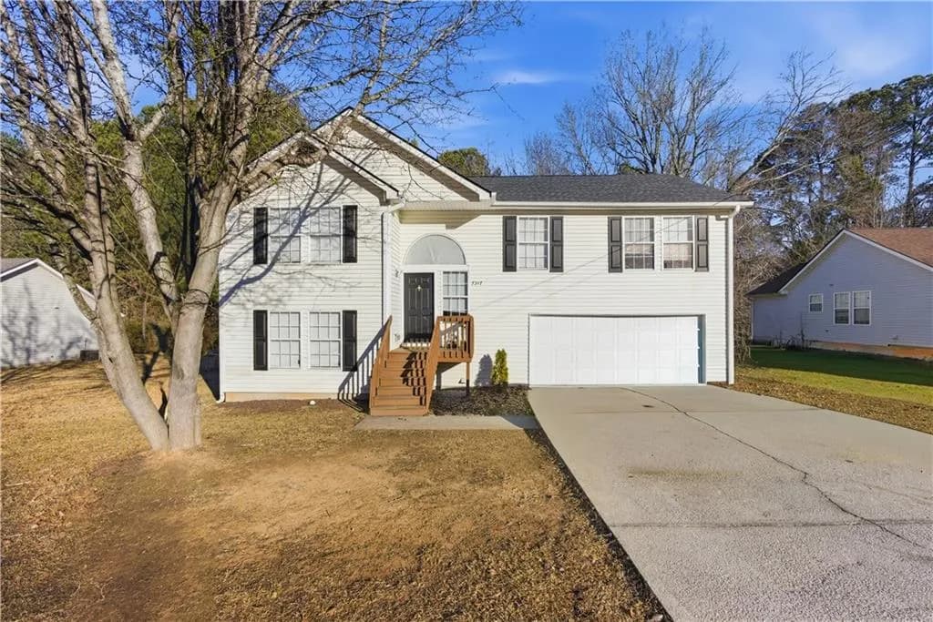 Split foyer home featuring driveway and a garage