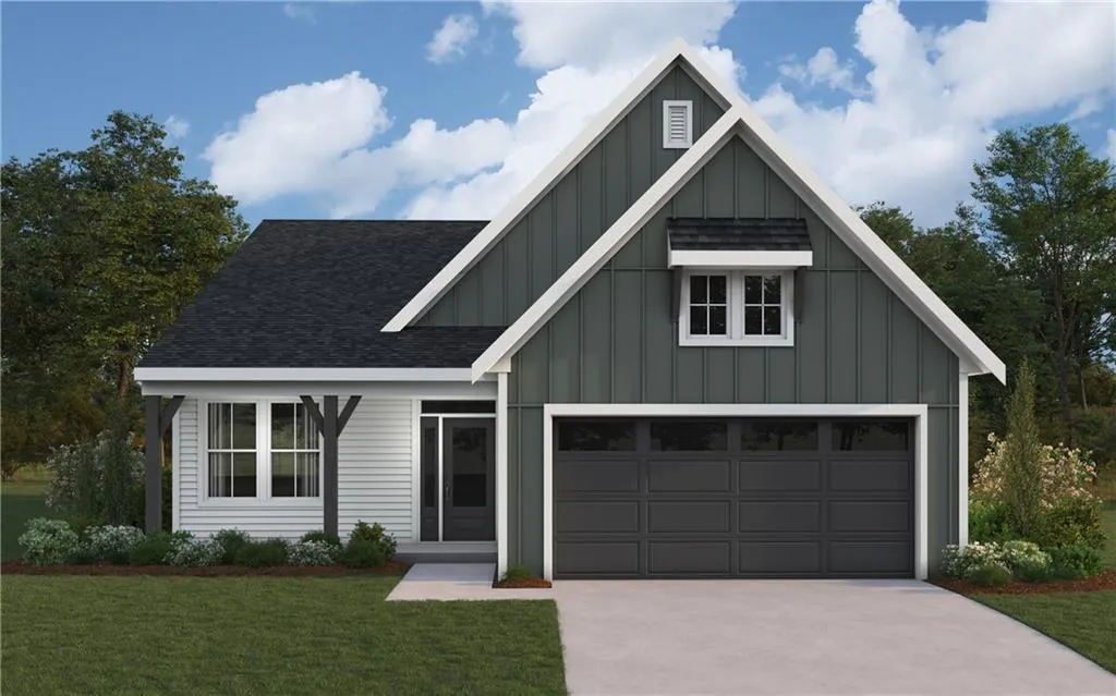 View of front of home featuring board and batten siding, a front yard, a shingled roof, and concrete driveway