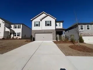 View of front of property featuring a garage and driveway