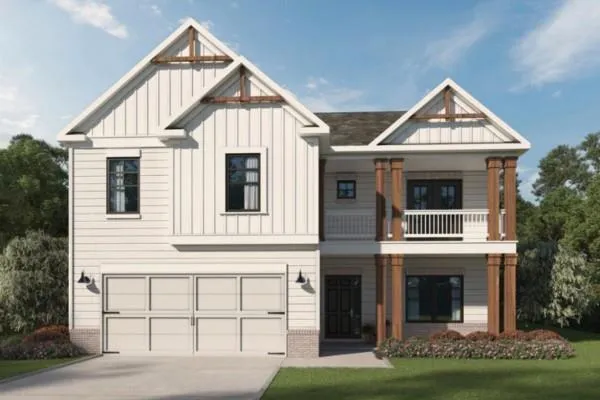 View of front of house with brick siding, board and batten siding, concrete driveway, and a garage