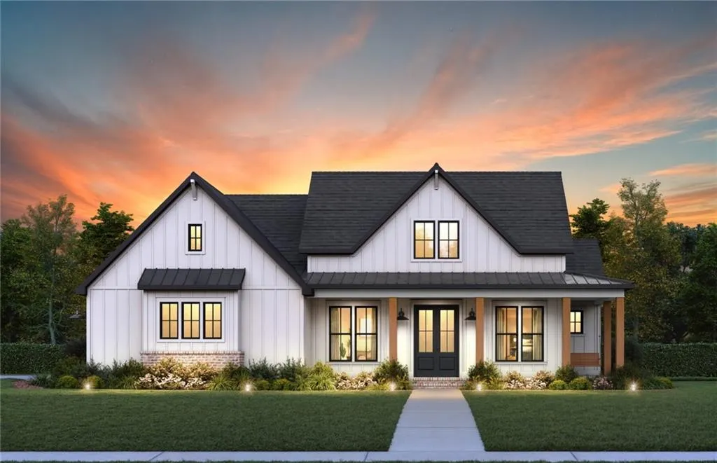 Modern farmhouse with board and batten siding, a standing seam roof, a porch, a front lawn, and roof with shingles