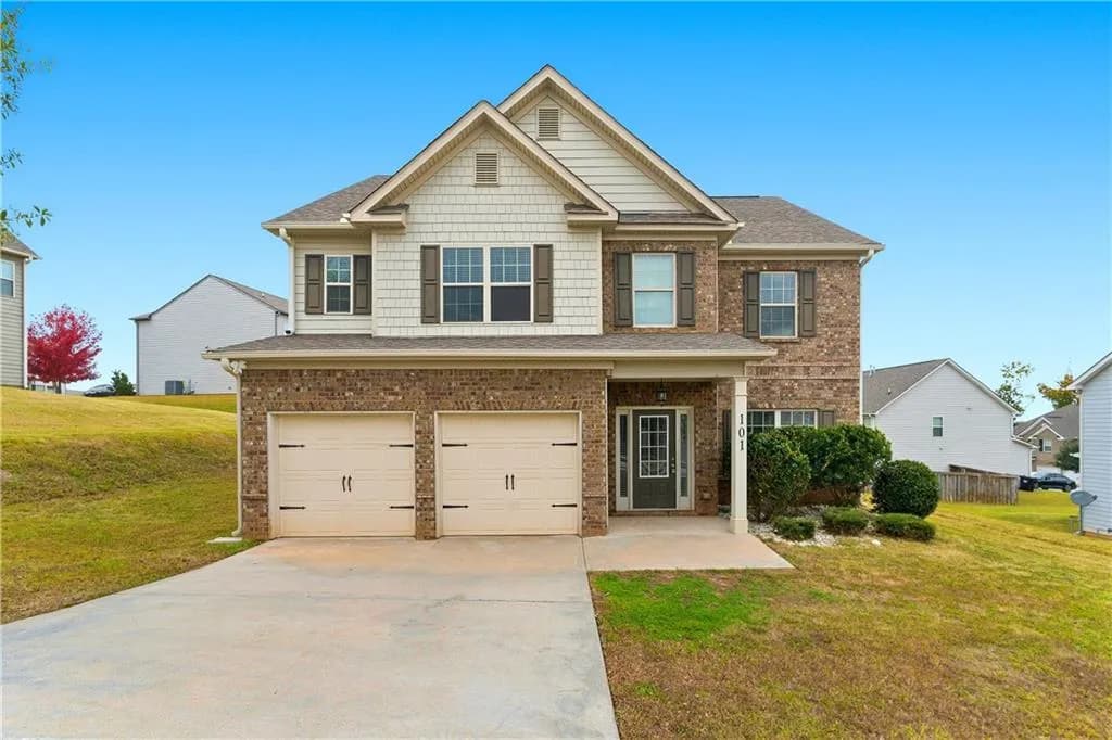 Craftsman-style home with a front lawn, an attached garage, concrete driveway, and brick siding