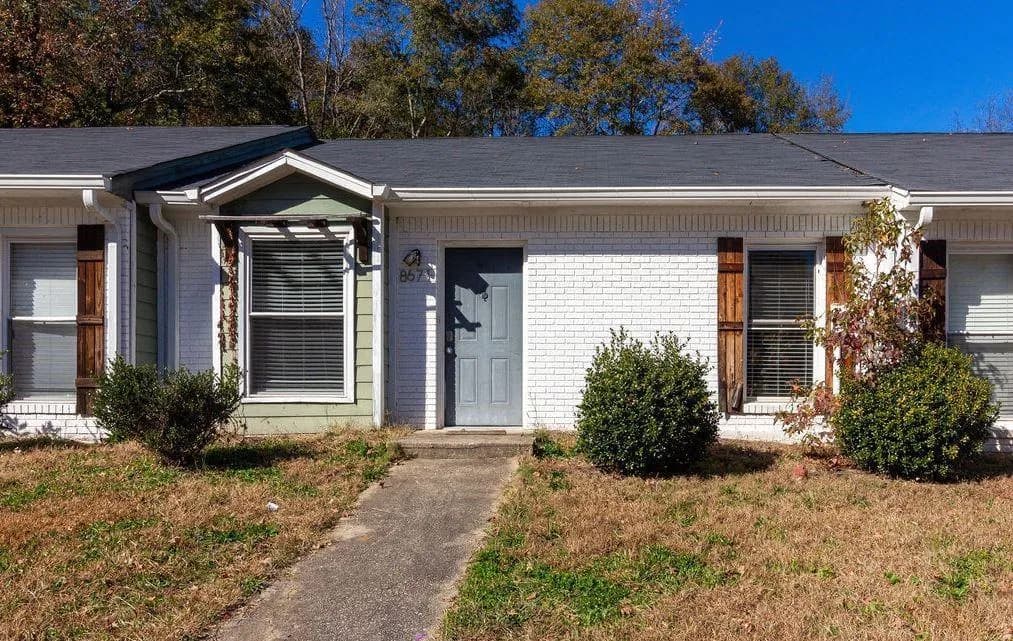 View of front of house featuring brick siding and a front yard