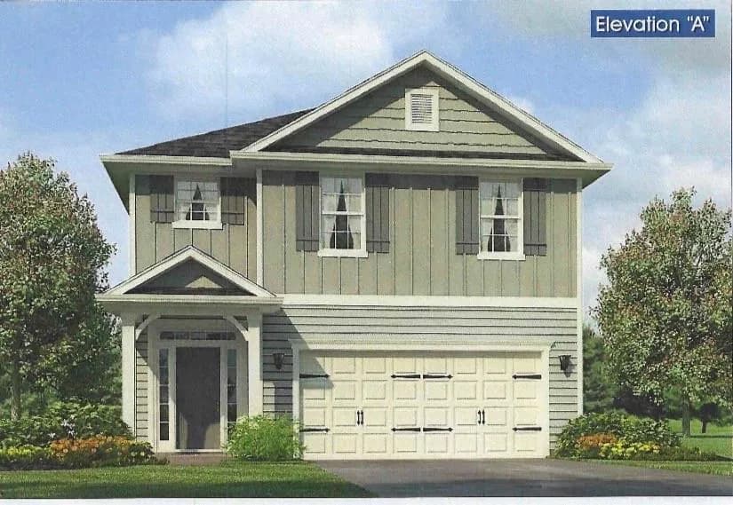 Craftsman-style house featuring board and batten siding, a garage, and driveway