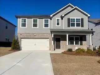 Craftsman inspired home featuring a porch, an attached garage, and concrete driveway