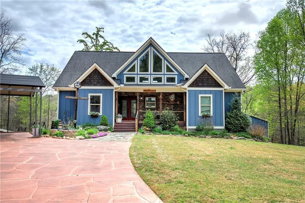 View of front facade featuring covered porch, a front lawn, and a shingled roof