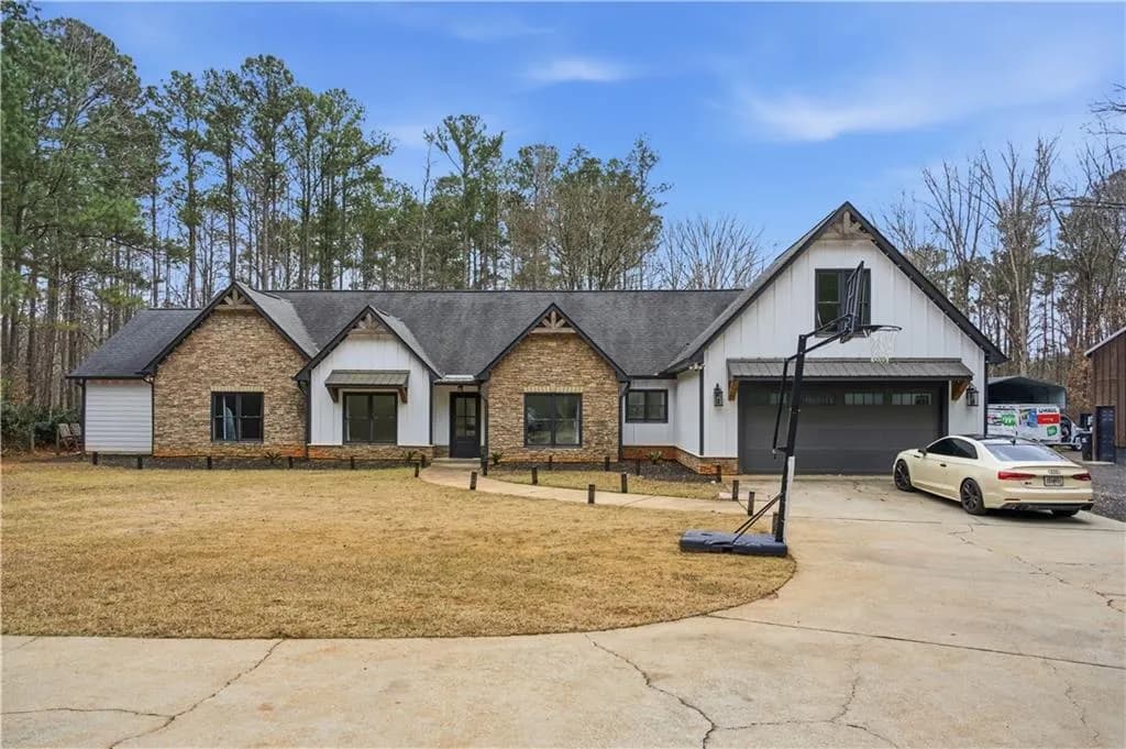 Modern farmhouse with board and batten siding, driveway, a garage, and a front yard