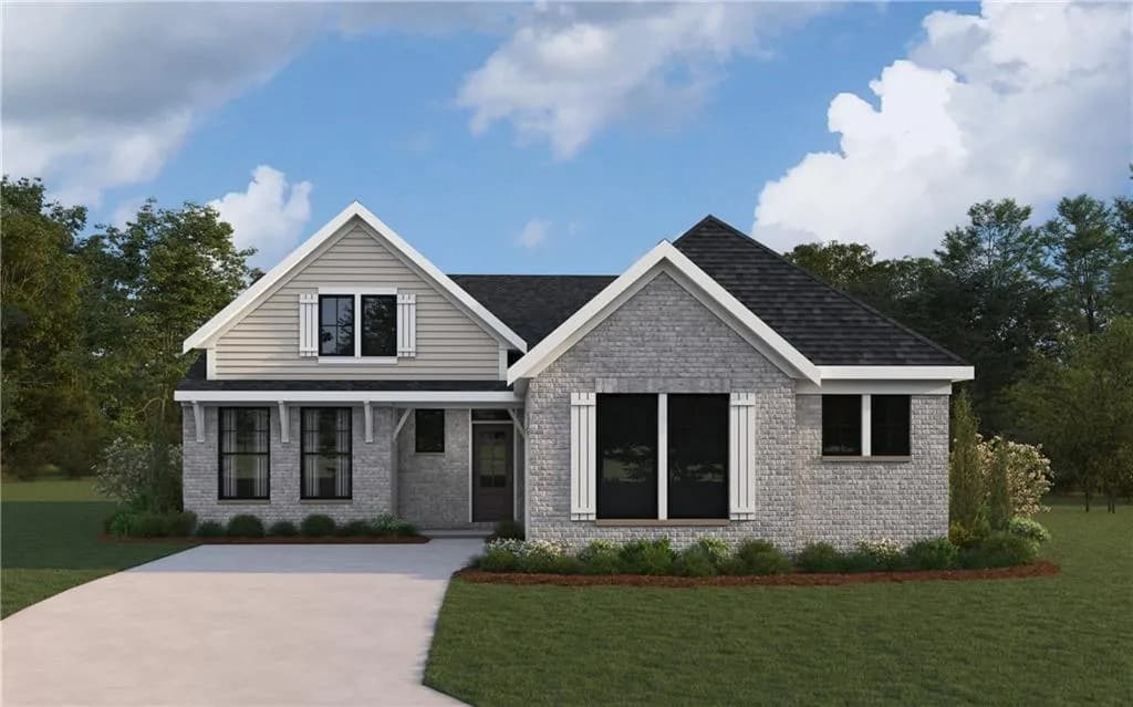 View of front facade featuring a front yard, brick siding, and a shingled roof
