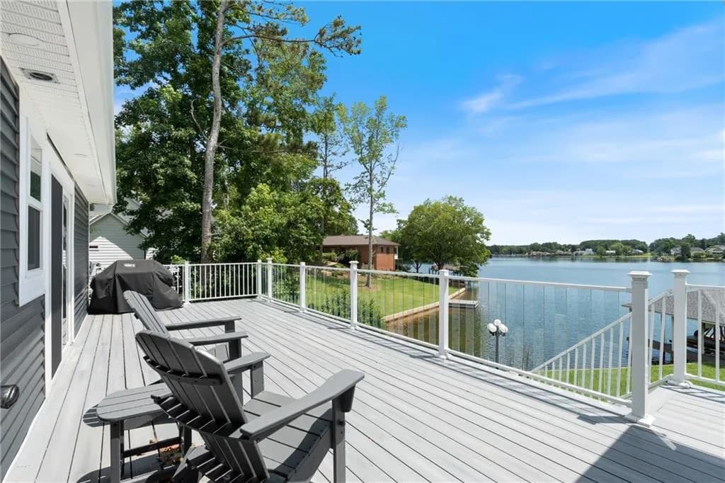 Wooden terrace with grilling area and a water view