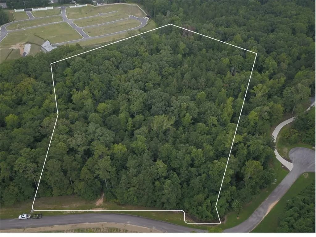 Aerial view of property and surrounding area with property parcel outlined