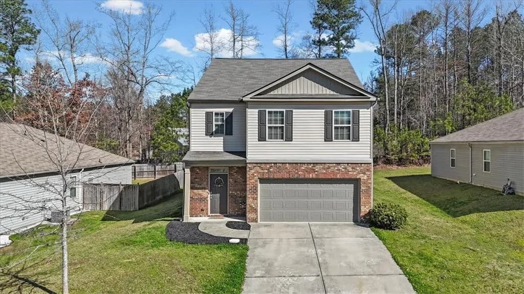 View of front of home featuring board and batten siding, concrete driveway, brick siding, an attached garage, and a shingled roof