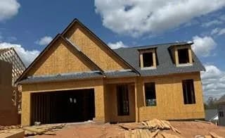 Property under construction featuring a garage