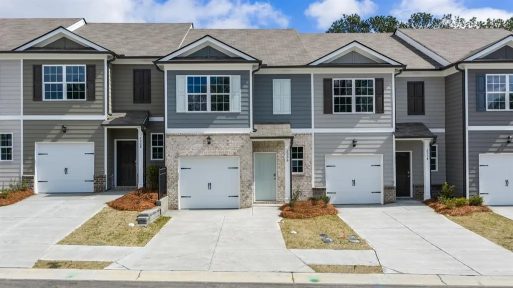 Craftsman house featuring brick siding, roof with shingles, driveway, and a garage