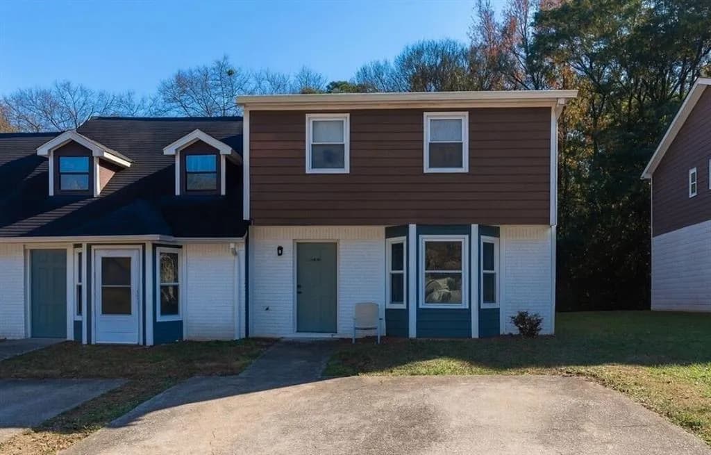 View of front of property featuring brick siding and a front yard